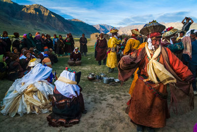 People on landscape against sky