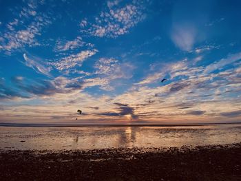 Scenic view of beach against sky during sunset