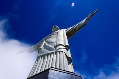 Low angle view of sculpture on building against sky