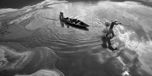 High angle view of men swimming in lake