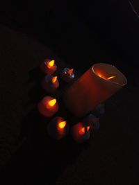 High angle view of illuminated candles on black background