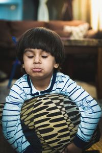 Portrait of boy standing at home