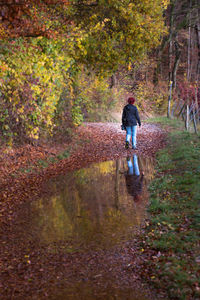 Full length of woman walking in forest