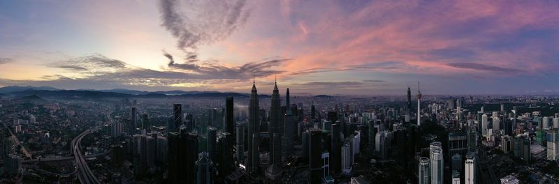 Panoramic view of modern buildings against sky during sunset