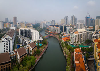 High angle view of buildings in city against sky