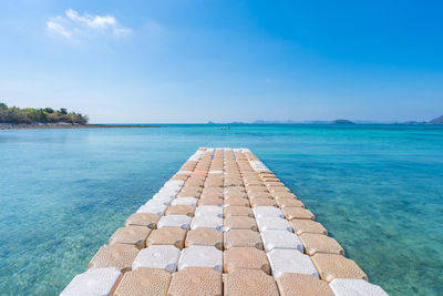 Beautiful tropical beach sea and sand with floating walkway pontoon in andaman sea thailand.