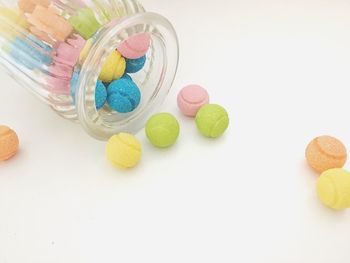 Close-up of multi colored candies against white background