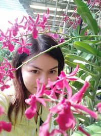 Portrait of woman with pink flowers