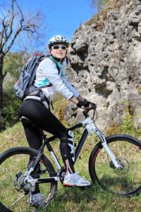Woman riding bicycle on mountain