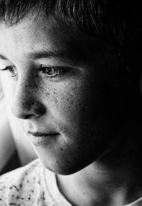 Close-up of man with freckles looking away