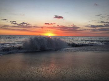 Close-up of sea against sunset sky