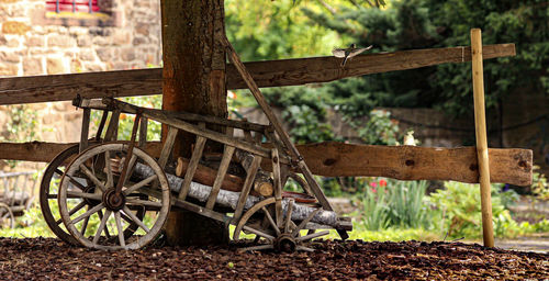 Close-up of bicycle on field against trees in forest