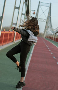 Young woman standing on bridge