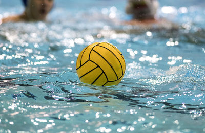 Close-up of yellow ball floating on water