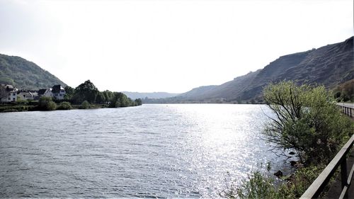 Scenic view of lake and mountains against clear sky