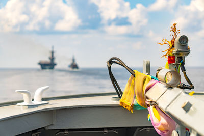 Close-up of yellow toy by sea against sky