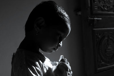 Close-up of cute girl in darkroom