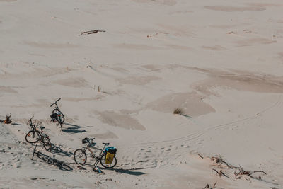 High angle view of bicycles on sand at beach