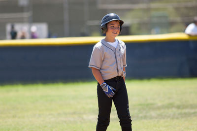 Little league player in baseball helmet smiling