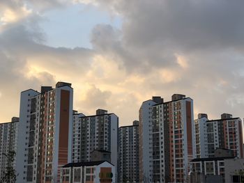 Low angle view of buildings against sky during sunset