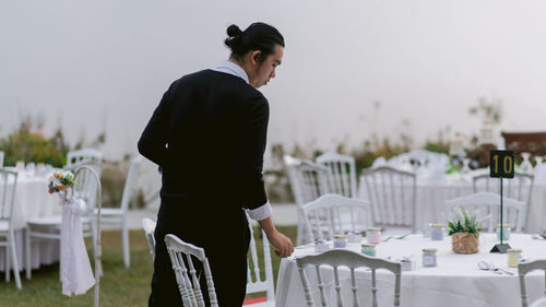 Man looking at camera while standing on table