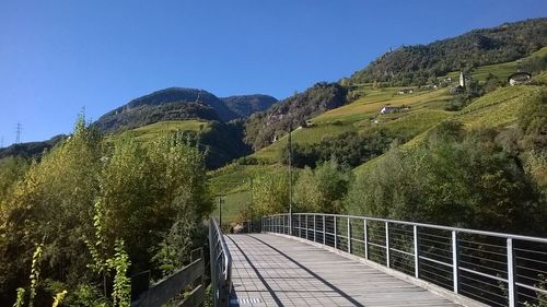 Scenic view of tree mountains against clear blue sky