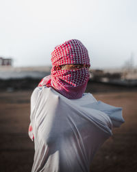 Man wearing hat standing on field