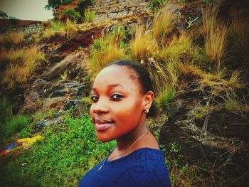 Portrait of smiling young woman on field