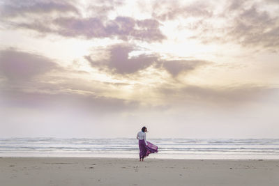 Full length of man on beach against sky
