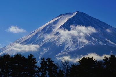 Low angle view of mountain against blue sky