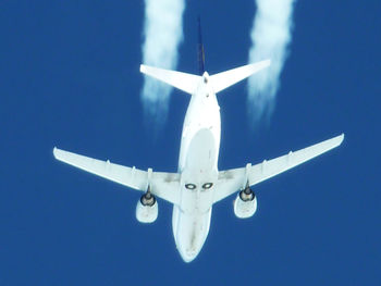 Low angle view of airplane flying in sky