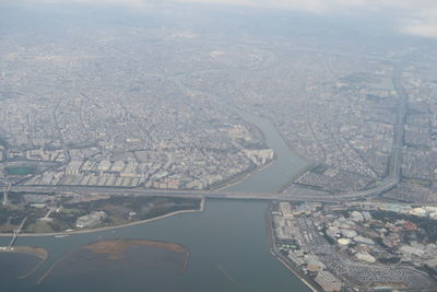 High angle view of cityscape and river against sky