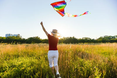 Woman with a kite in the field