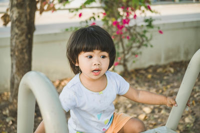 Cute girl playing on slide at park