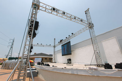 Low angle view of crane against sky