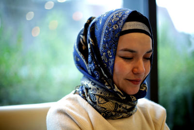 Close-up portrait of a young woman looking away