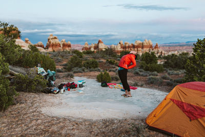 Female camper does backbend stretches at dusk in the desert