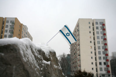 Buildings in city against sky during winter