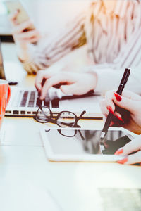 Midsection of woman working on table