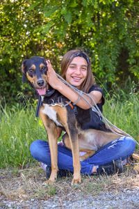 Portrait of a dog wearing sunglasses standing against plants