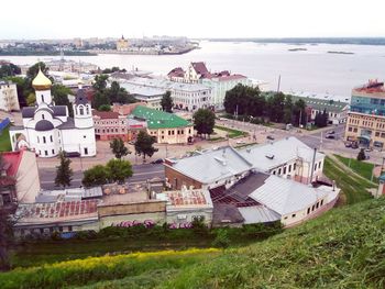 High angle view of houses by sea against sky