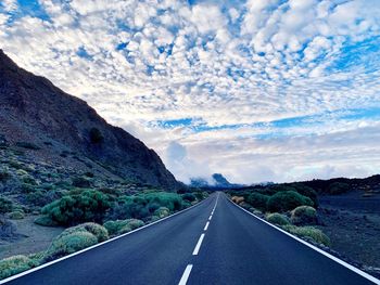 Empty road by mountain