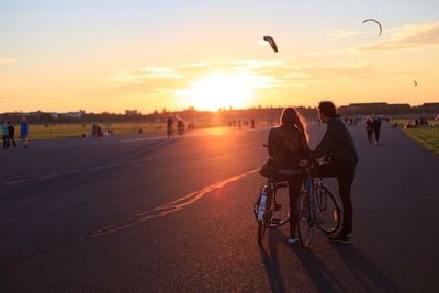 People on road at sunset