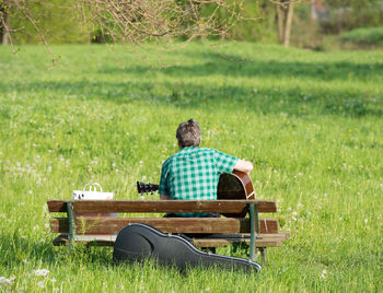 Musician playing in a field in spring