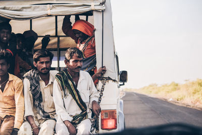 People standing on road against sky