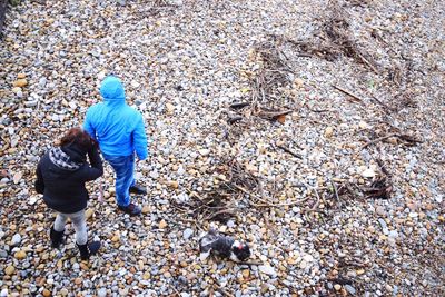 High angle view of people standing at beach