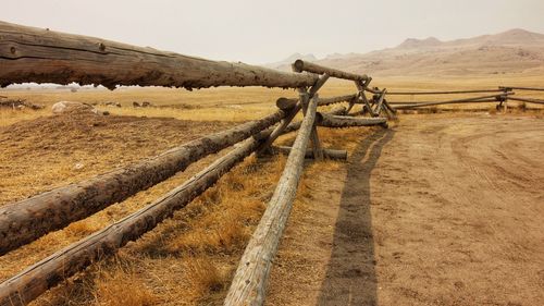 Fence on field against sky