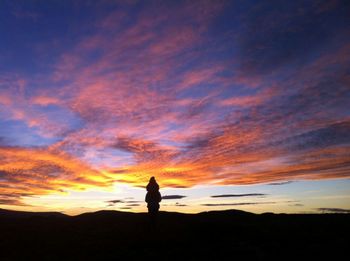 Silhouette of person standing on landscape