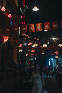 People standing in illuminated restaurant at night