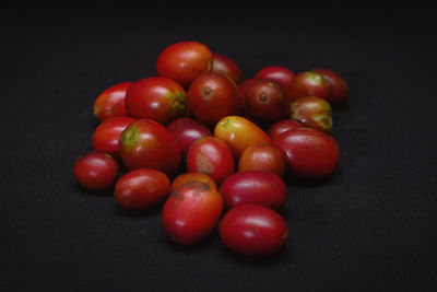 High angle view of tomatoes on table against black background
